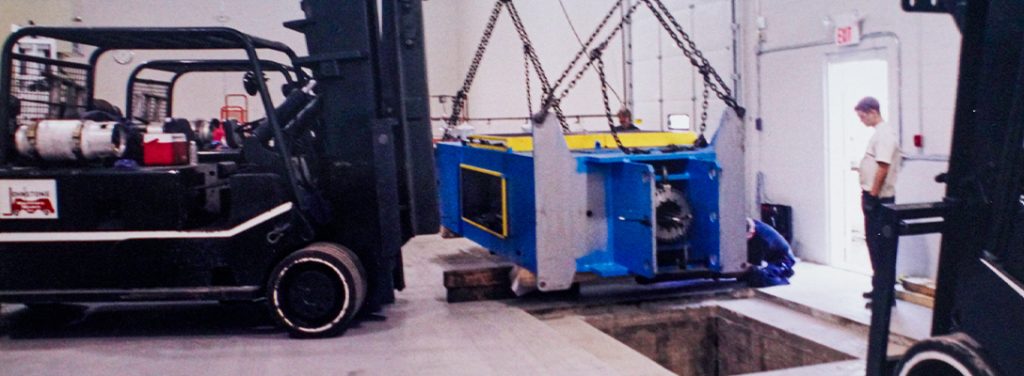 New machine being delivered to Toledo Metal Spinning plant after fire
