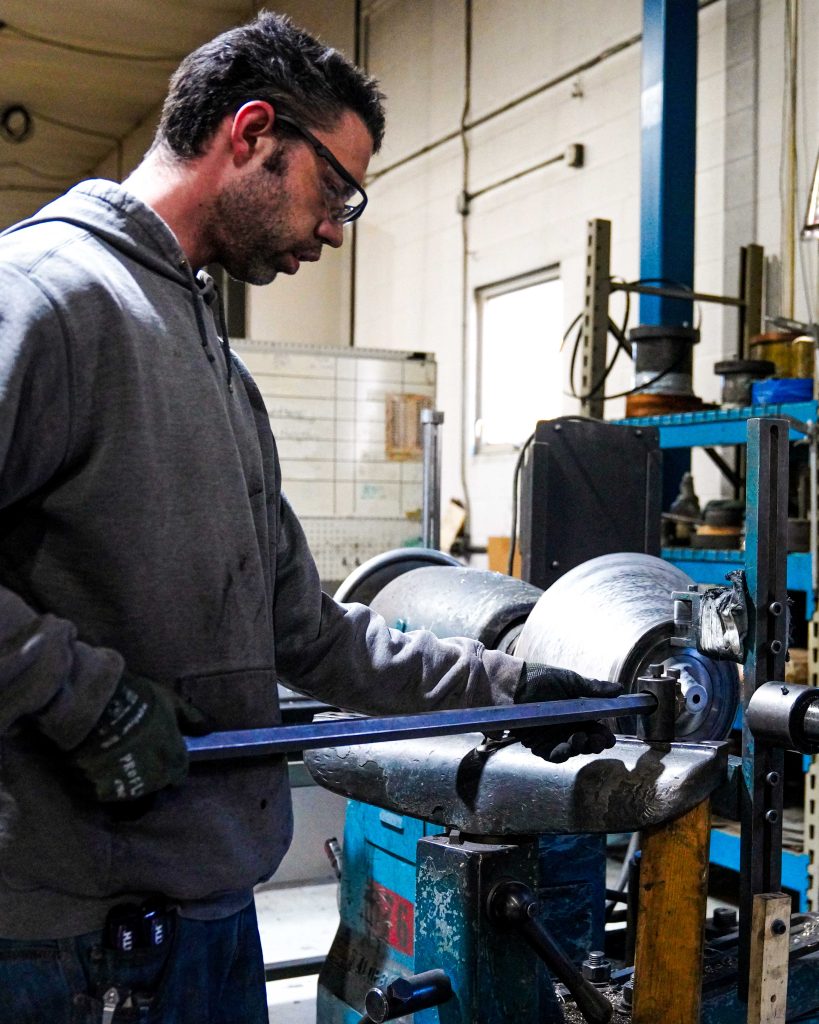 manual trimming on a metal spinning lathe