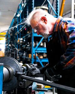 manual trimming on a metal spinning lathe