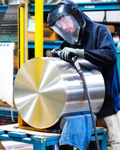 manually demurring a stainless steel part
