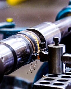manually trimming a small part on a lathe
