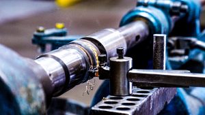 manually trimming a small part on a lathe