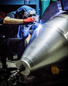 manually welding a cylinder extension onto a hopper